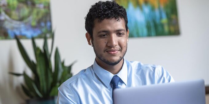 Student at a desk working on a computer